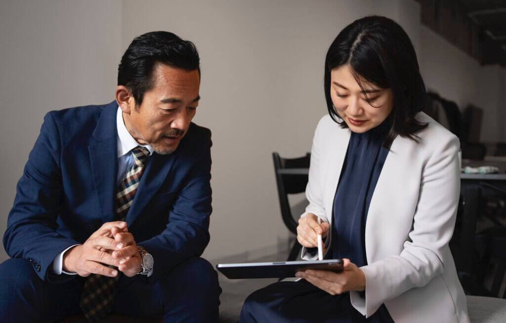 medium-shot-business-people-working-with-ipad-copy-1024x653 executive communication coaching can help you gain more visibility at work