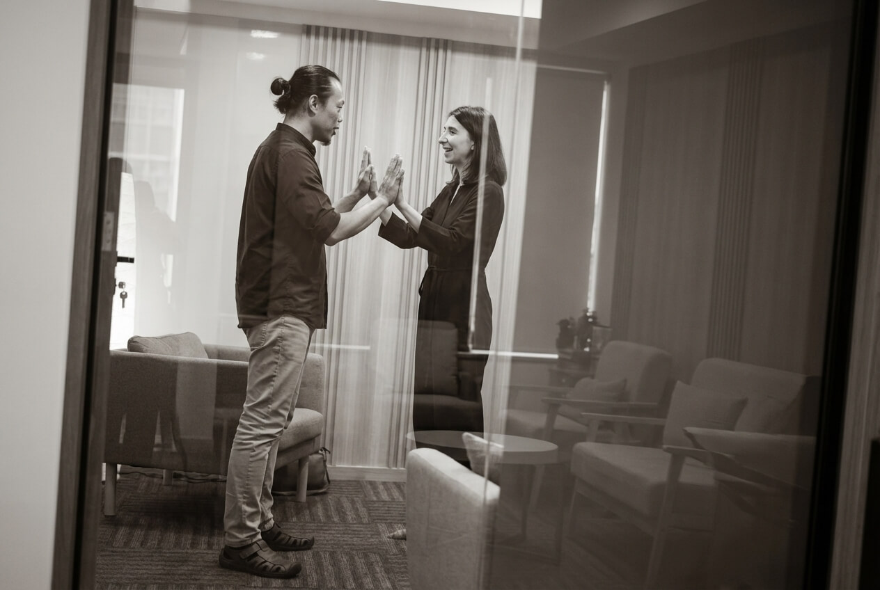 Public speaking coach in Singapore working with a senior executive on a presence-building exercise during a one-to-one communication coaching session